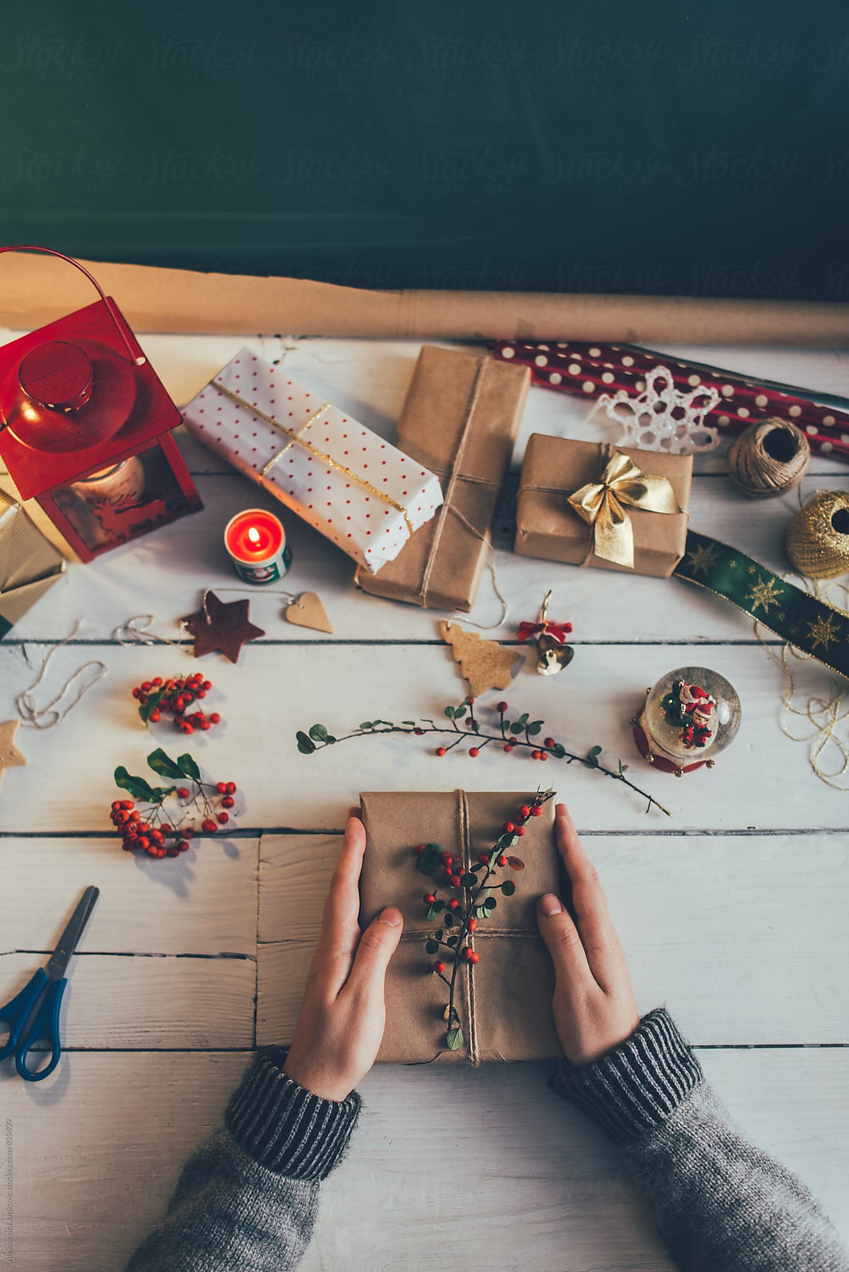 Anonymous Woman Decorating Christmas Presents On The White Table