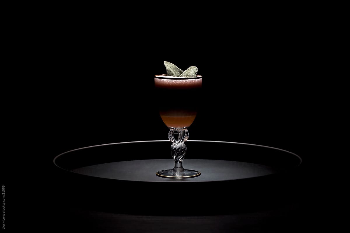 Small dark layered cocktail on tray