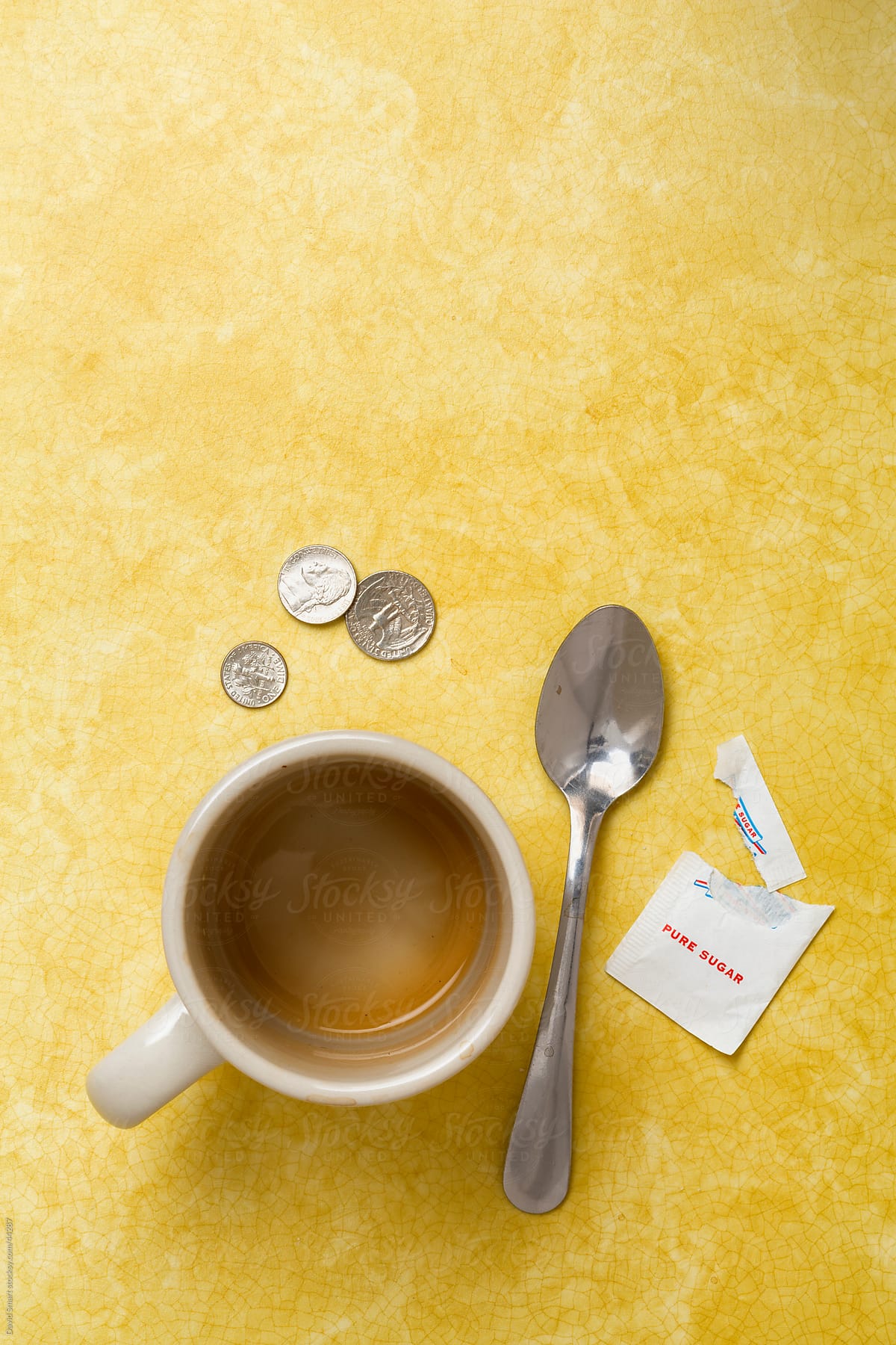 Retro coffee mug, spoon, sugar tip on diner counter