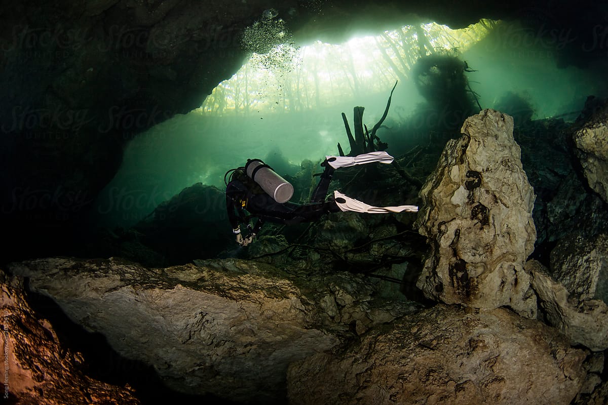 A scuba diver swimming in Mexico's  Cenote Chac-Mool