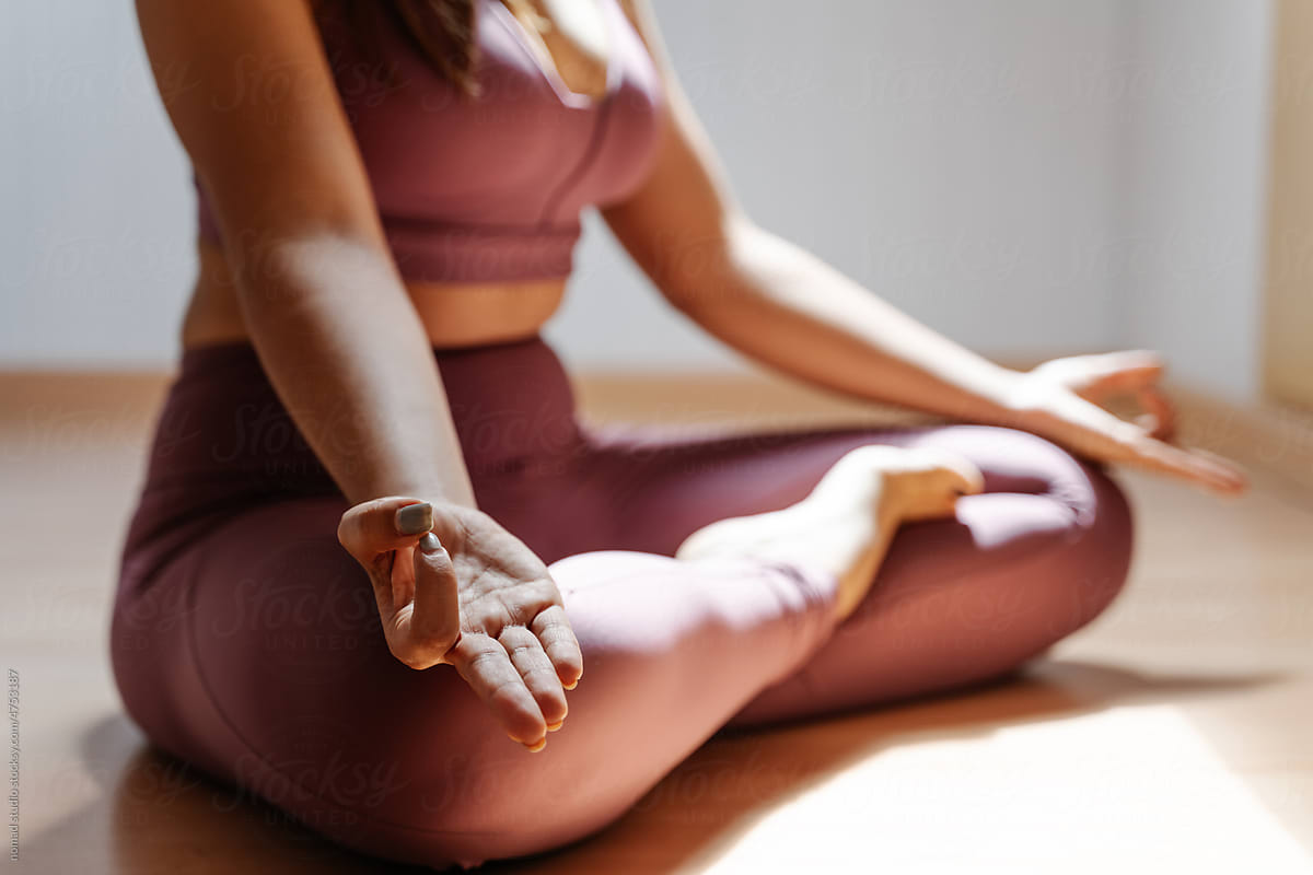 Fit woman practicing meditation in lotus pose