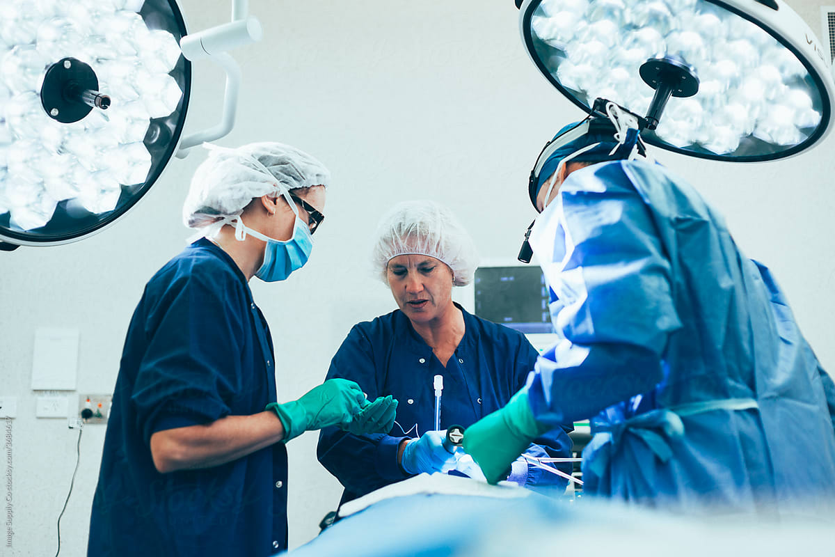 Surgeon and nurses in operating theatre