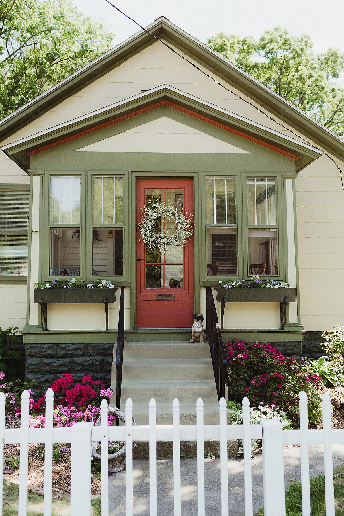 Traditional Bungalow Front Porch with White Picket Fence