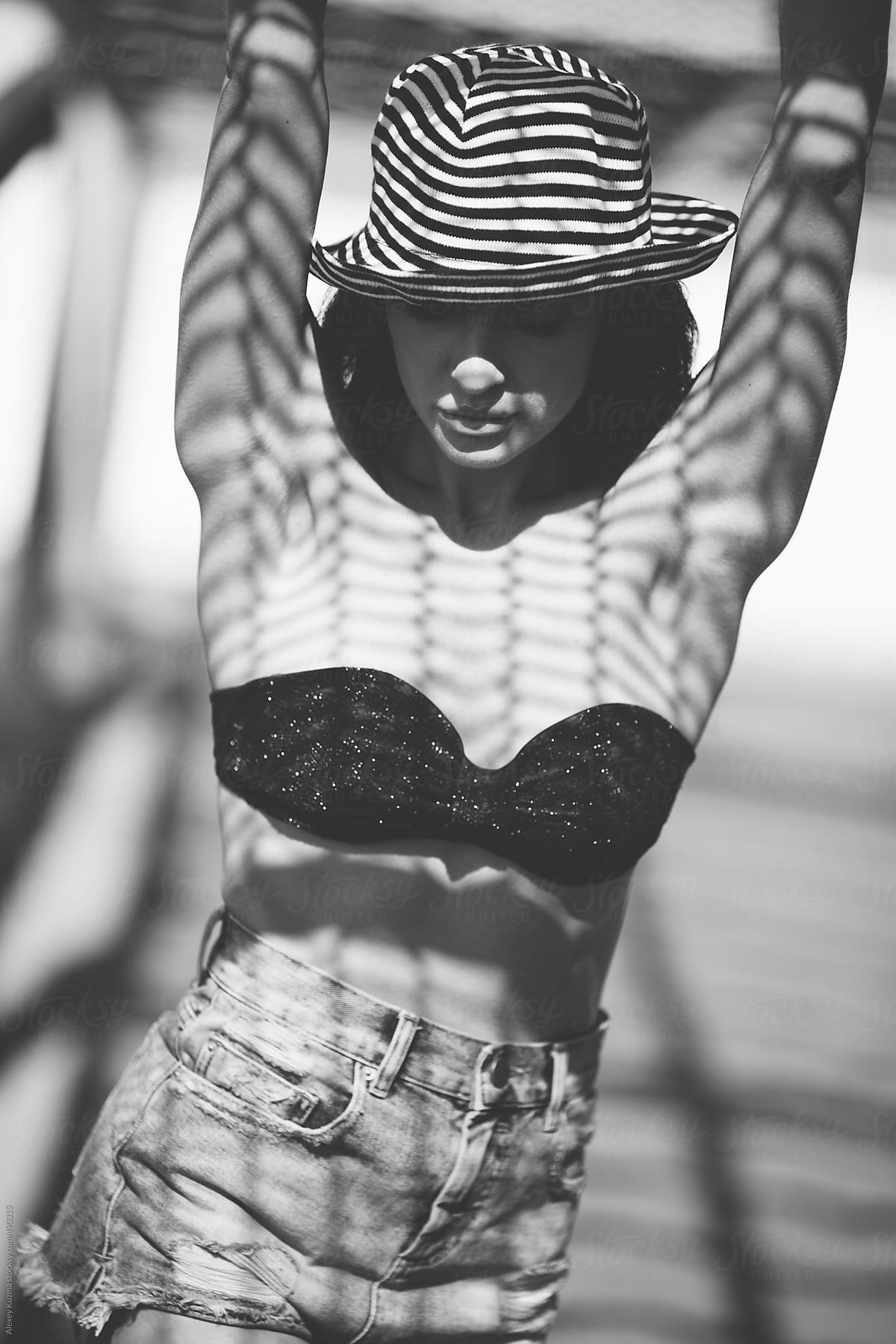 beautiful woman with a geometric patterned shadow on her body .