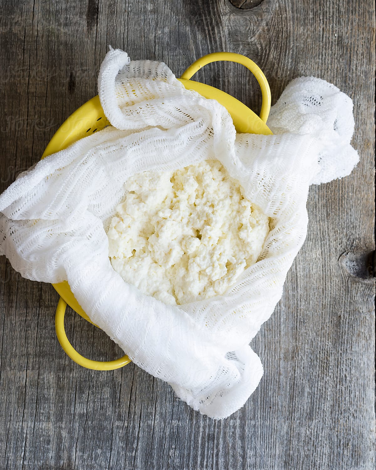 Homemade ricotta cheese in cheesecloth