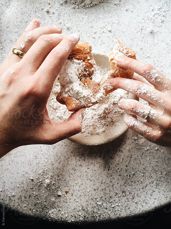 Couple Pulling Apart Iconic Beignet in New Orleans