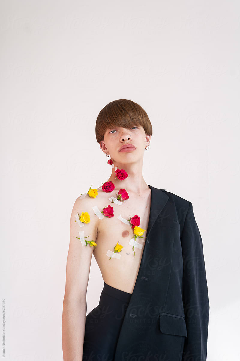 Portrait Of Young Handsome Androgynous Guy With Roses