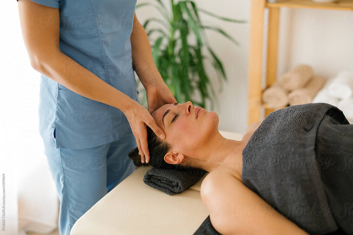 Mature woman having face massage at spa