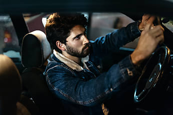 Young Man In Car In Nighttime by Stocksy Contributor Javier Díez -  Stocksy