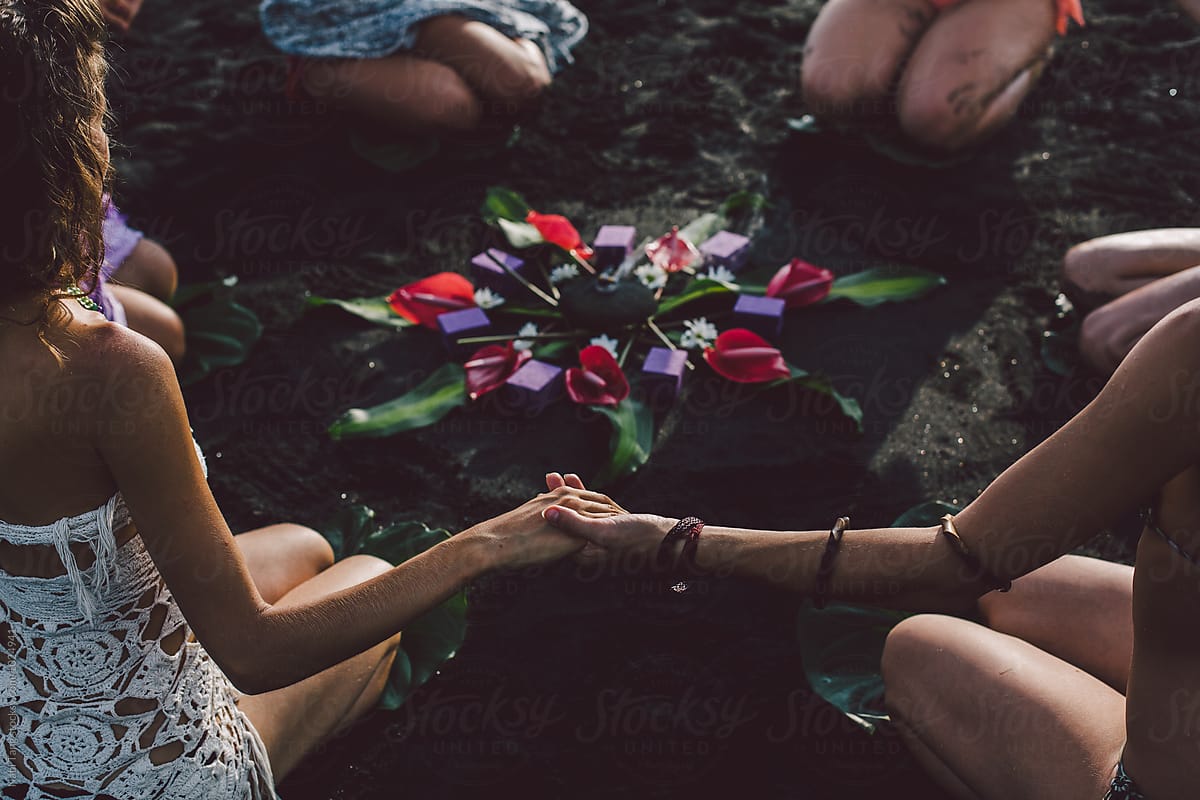 Women On The Beach Join Hands Around The Flower Mandala By Stocksy Contributor Nabi Tang