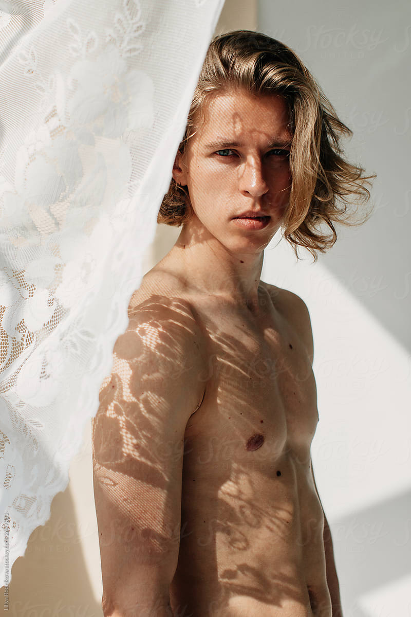 Blond handsome man with floral shadow on his skin