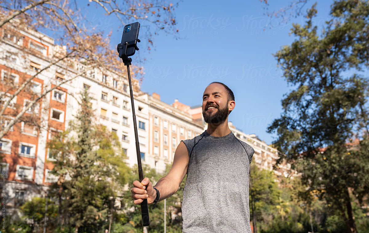 Athlete Using Phone On Selfie Stick Outdoors