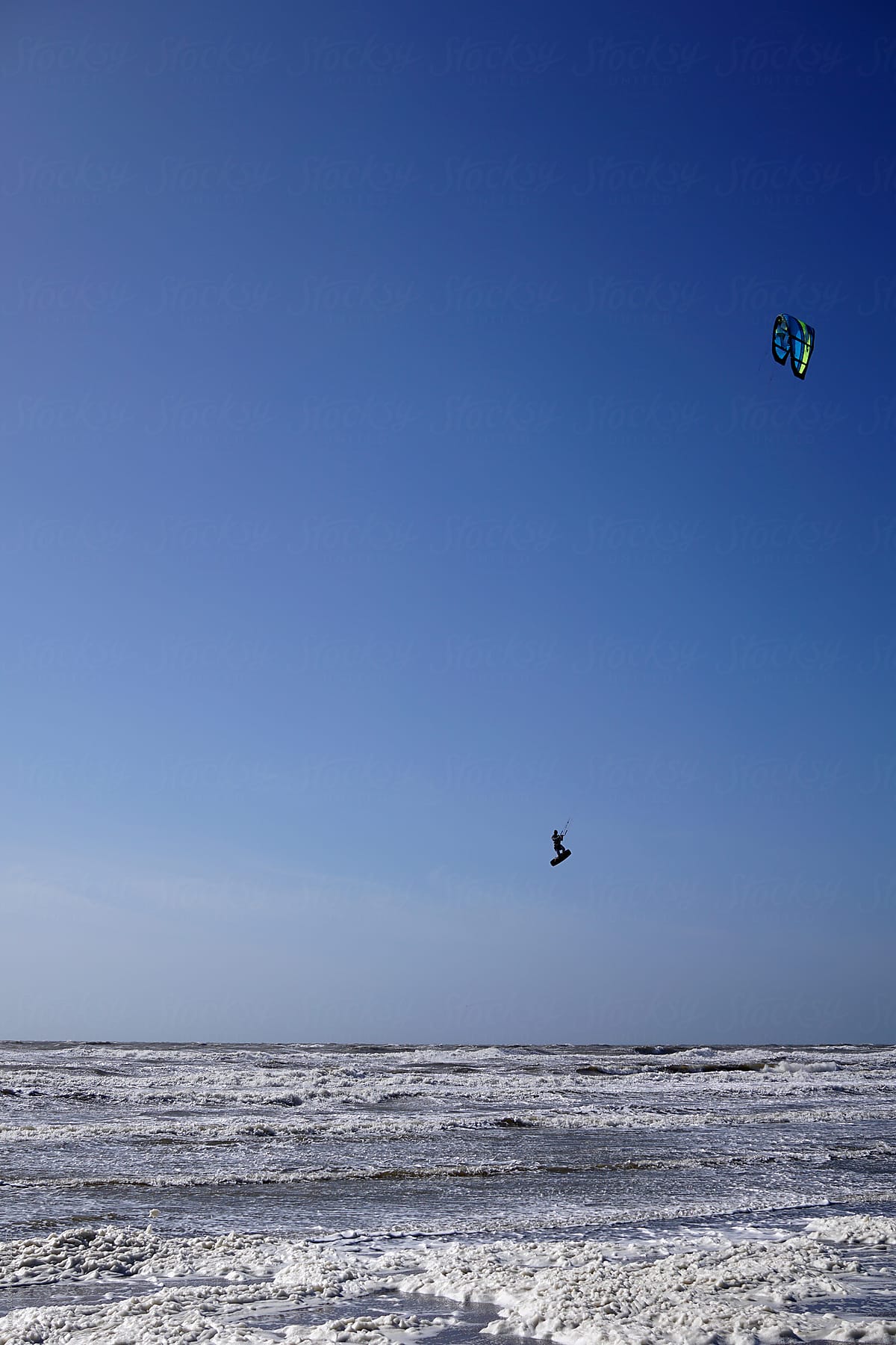 Kite surfer jumping extremely high