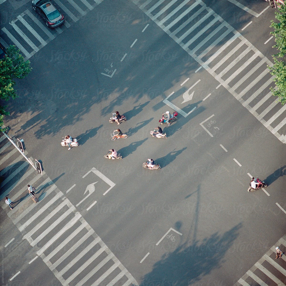 High angle of the crosswalk with some pedestrians moving on