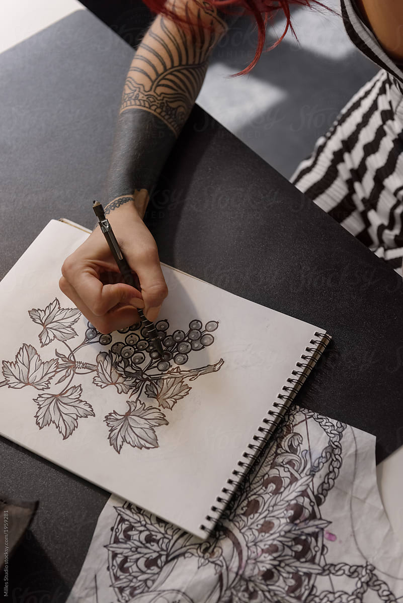 Crop woman creating tattoo sketch
