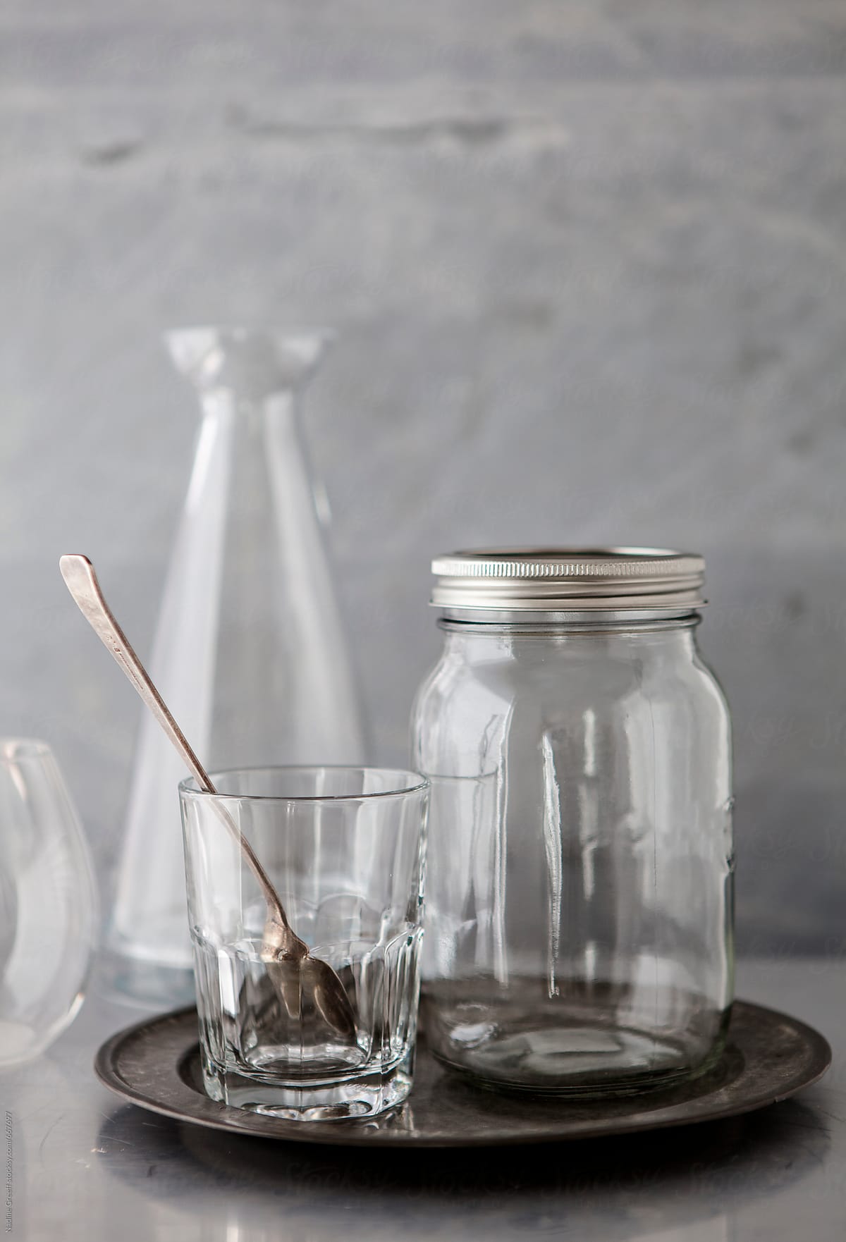 Kitchen Glassware, Drinking Glass, Glass Jar, Jug On Grey Plate by Stocksy  Contributor Nadine Greeff - Stocksy