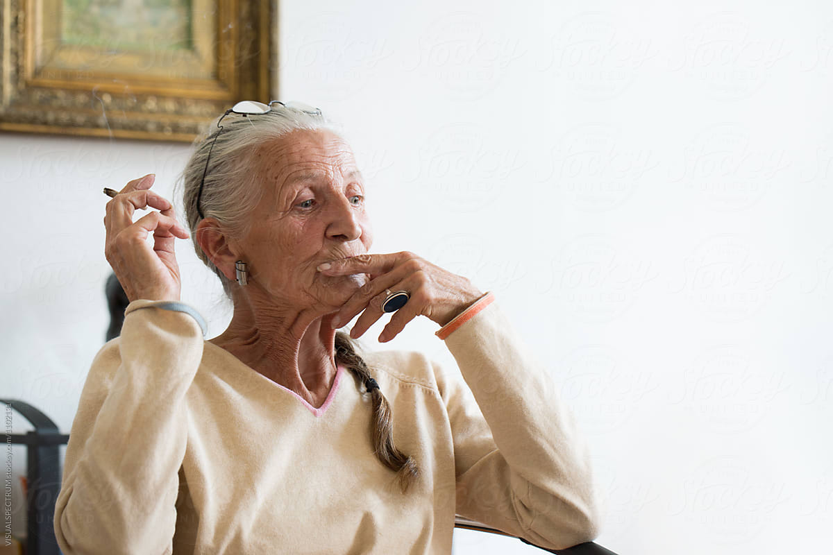 Portrait Of Senior Woman With Grey Hair Smoking At Home By Stocksy Contributor Visualspectrum