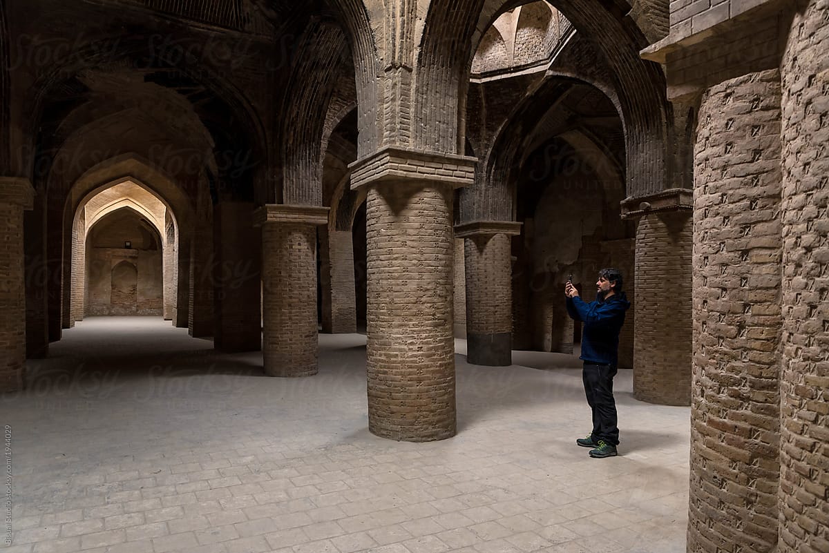 Man taking shots in old foundations of a mosque in Isfahan, Iran