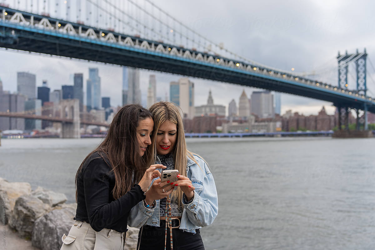 Two Tourist Girls Checking The Phone In New York.