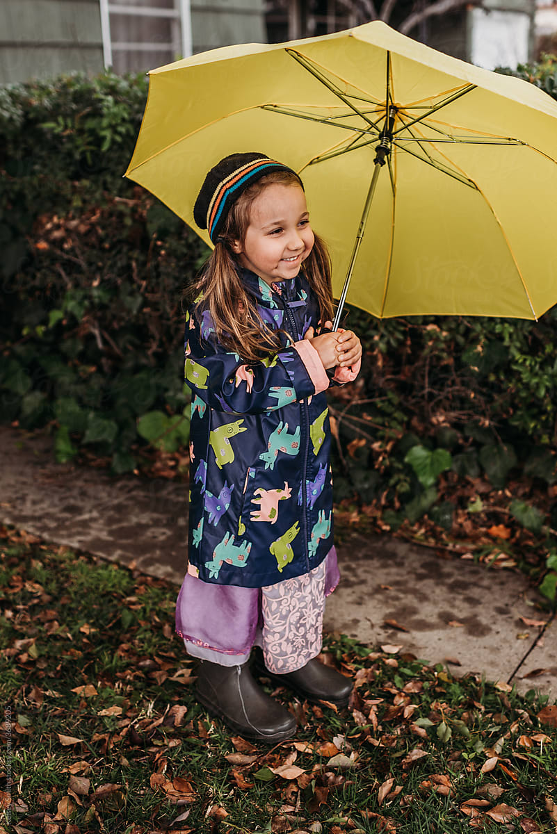 Girl holding umbrella in rainstorm