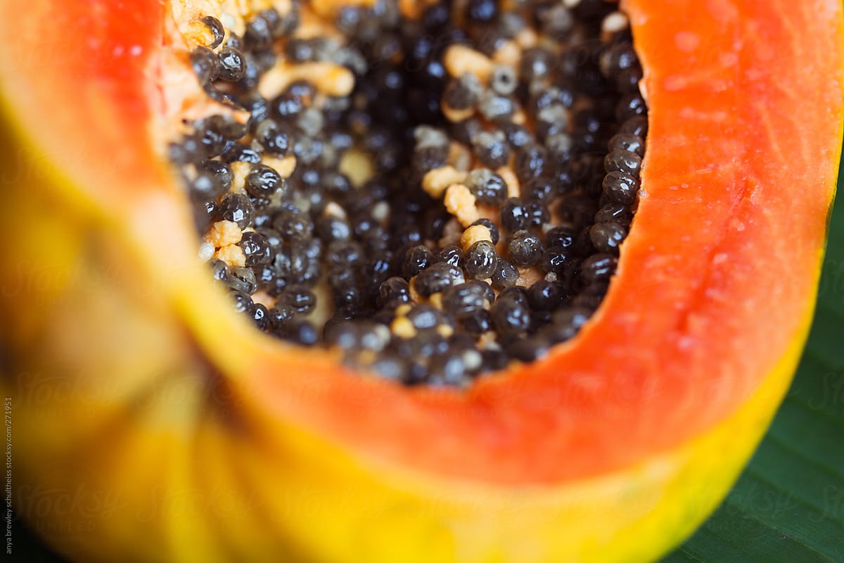 Cut open ripe papaya fruit with seeds
