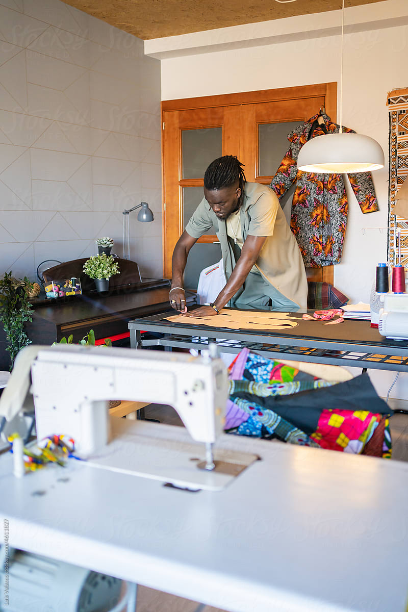 Creative Black Man Drawing Clothes In A Design Fashion Studio.
