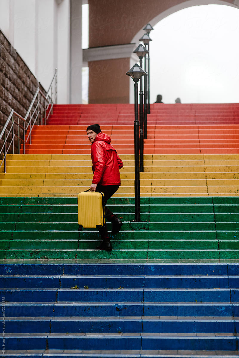 View of traveler walking up colorful stairs