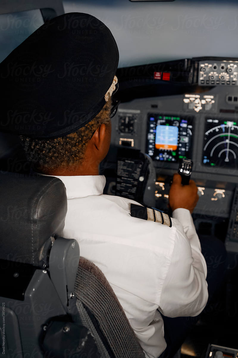Unrecognizable black male steering airplane
