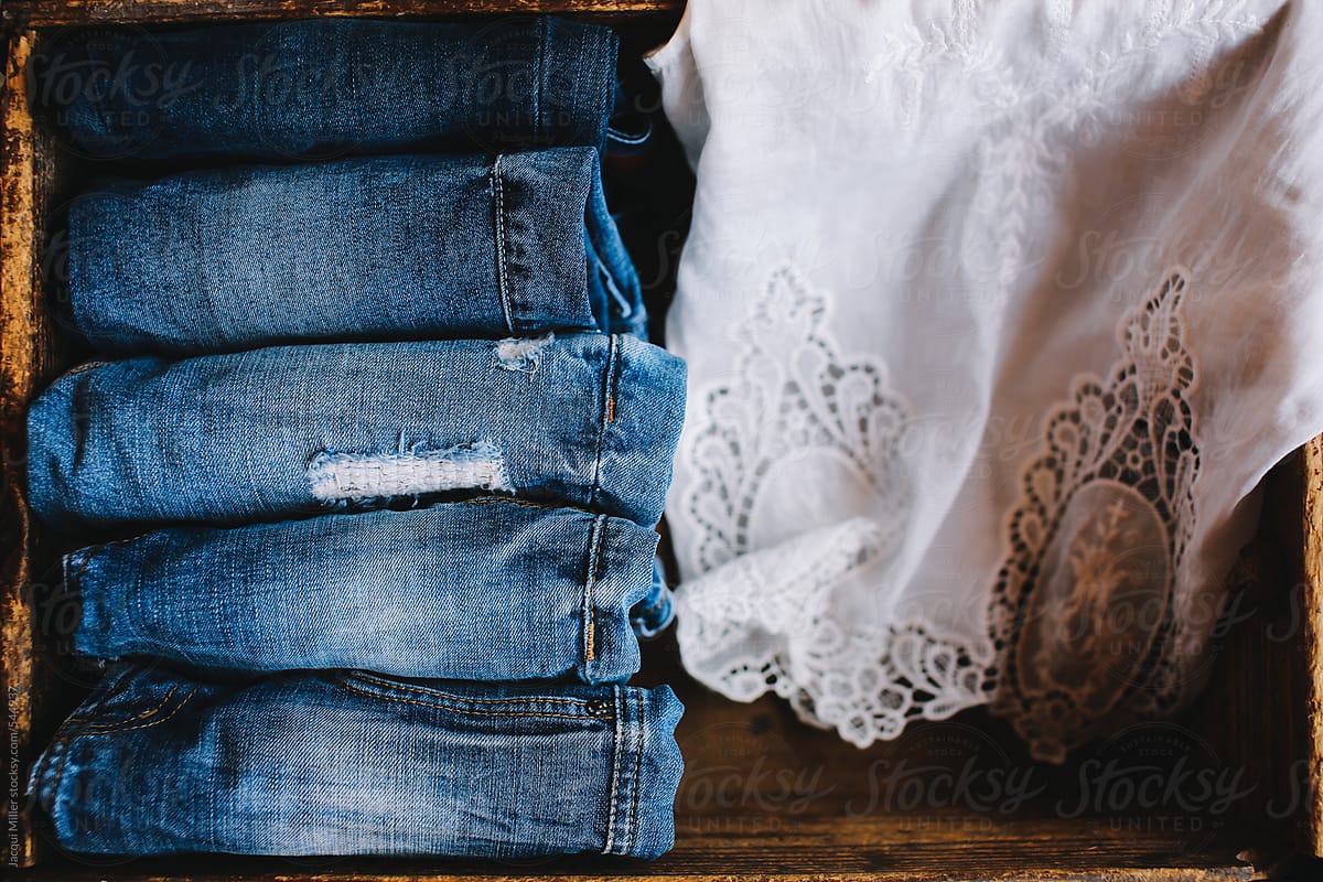 Selection of denim jeans with a white lace shirt
