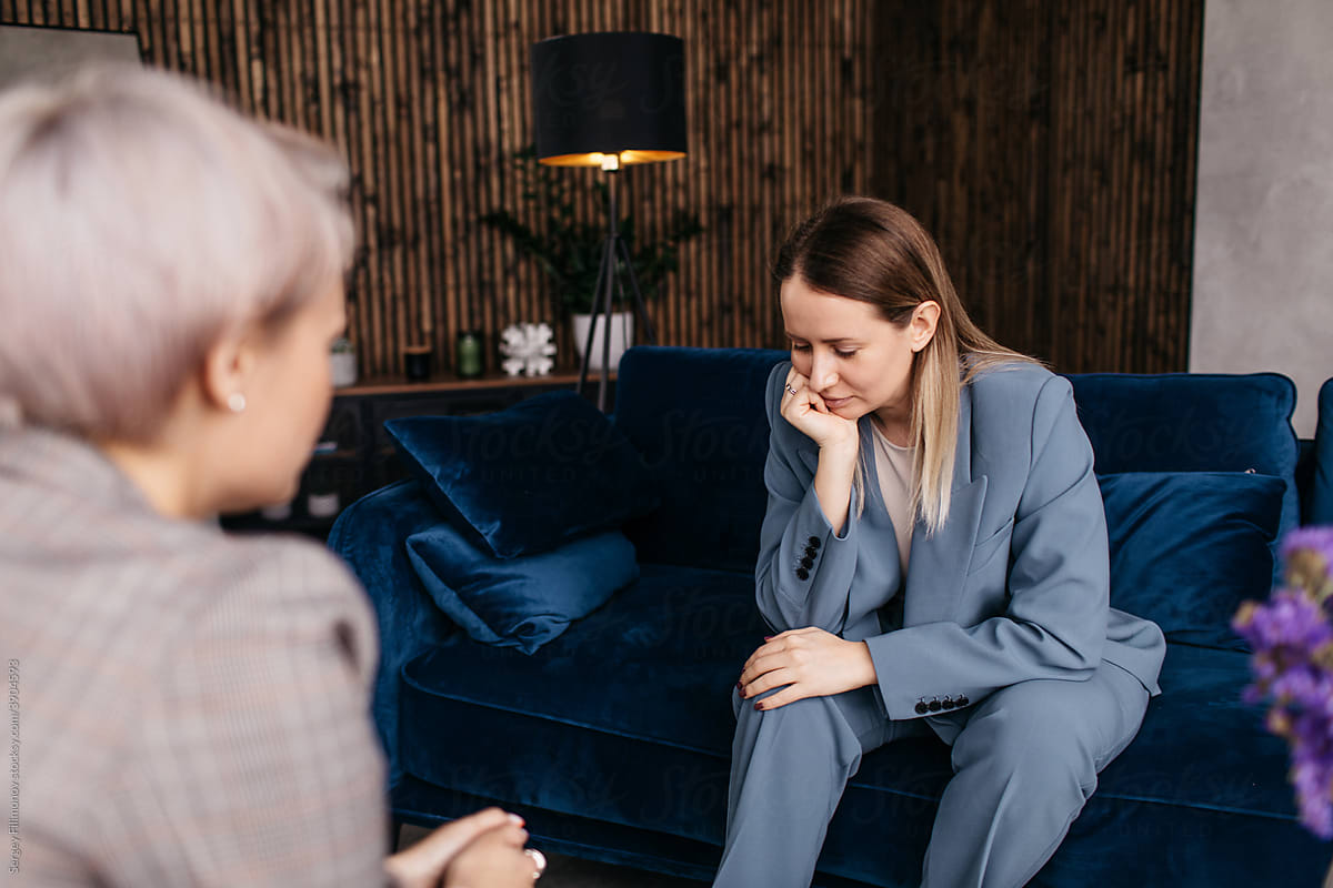 Upset woman sharing problems during psychotherapy session