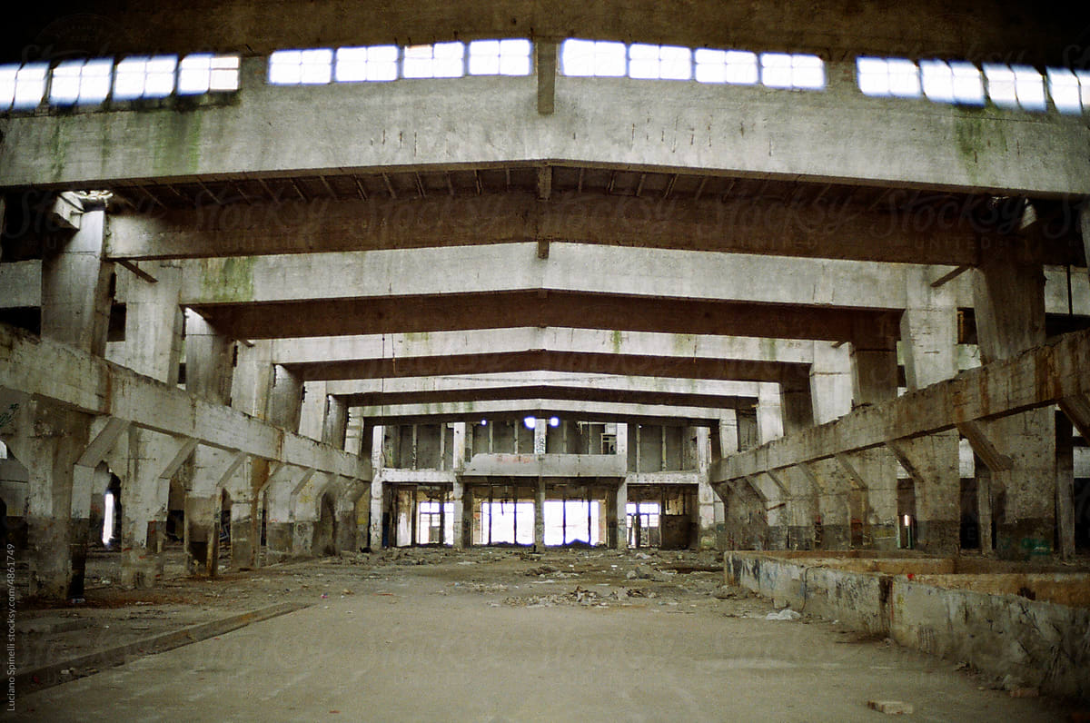 Inside abandoned industrial area with grey cement geometric colours
