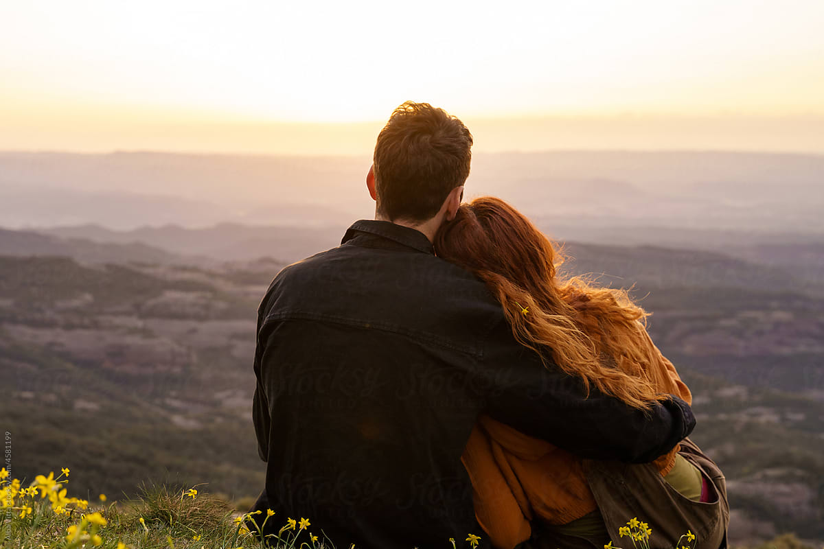 Portrait of young loving couple in the mountain at sunset