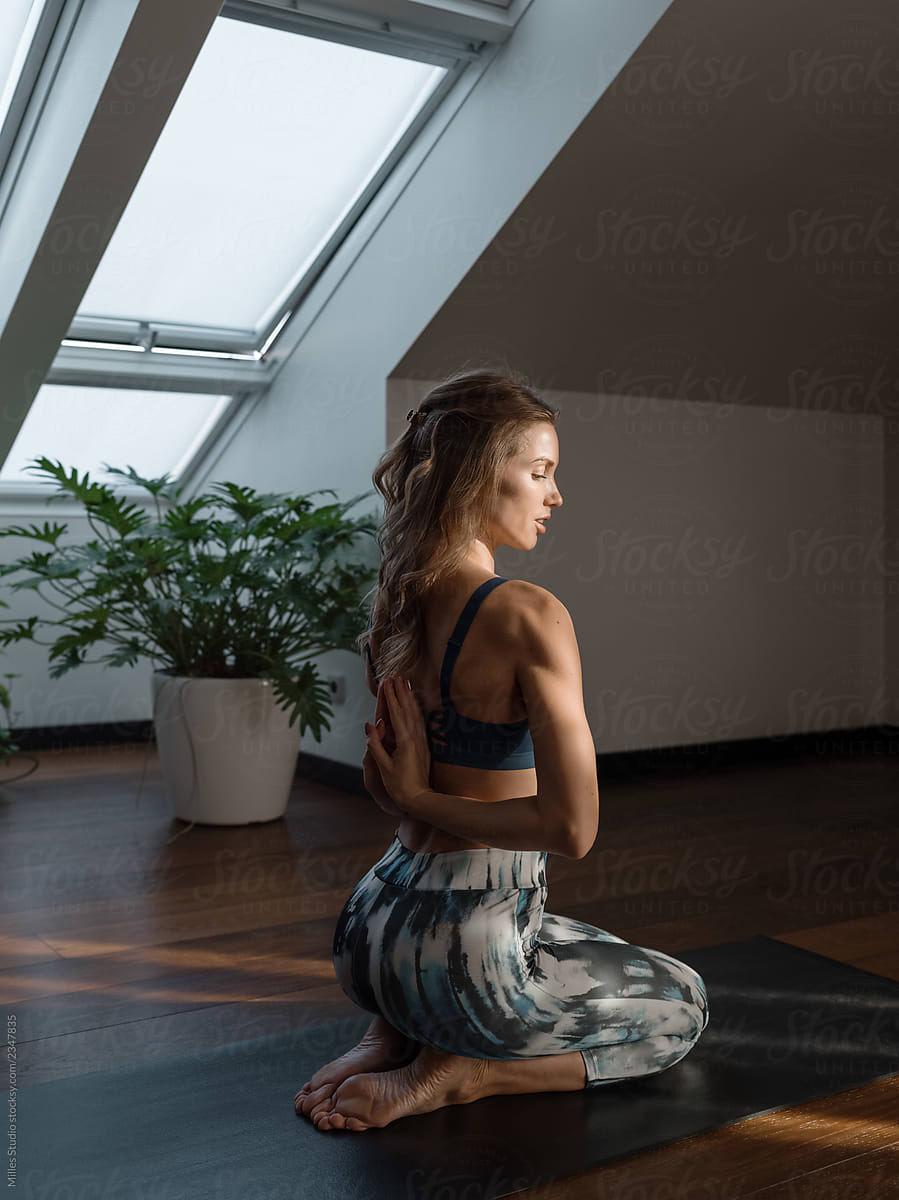 Skinny woman in yoga pose on mat