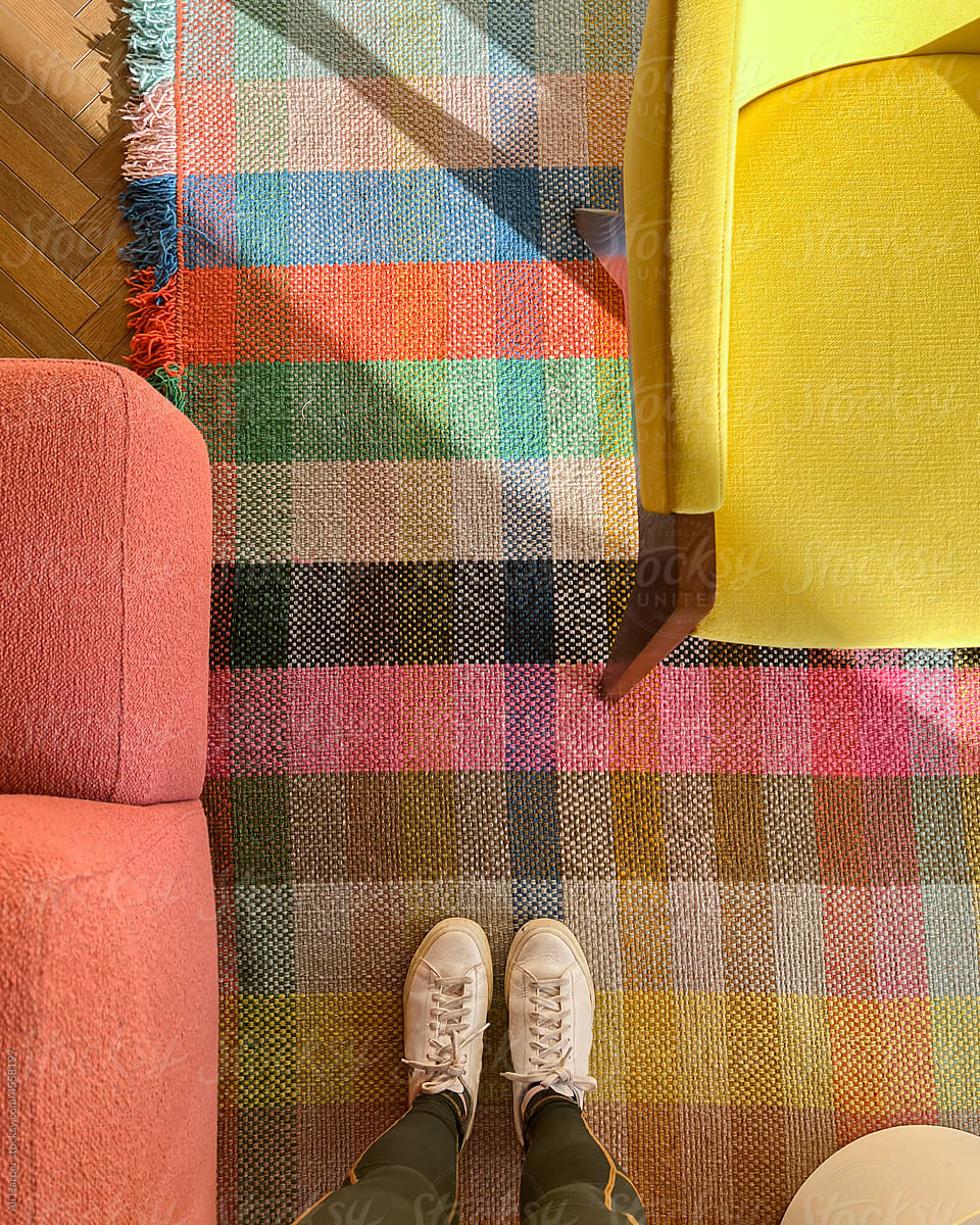 Woman standing on a colorful plaid rug