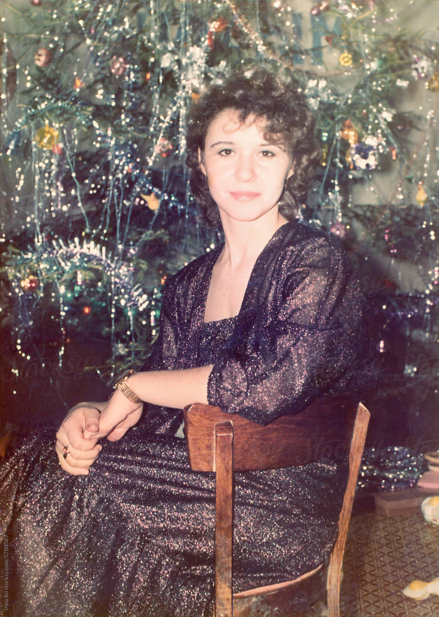 Vintage portrait from the 80s. A woman sits by the New Year tree