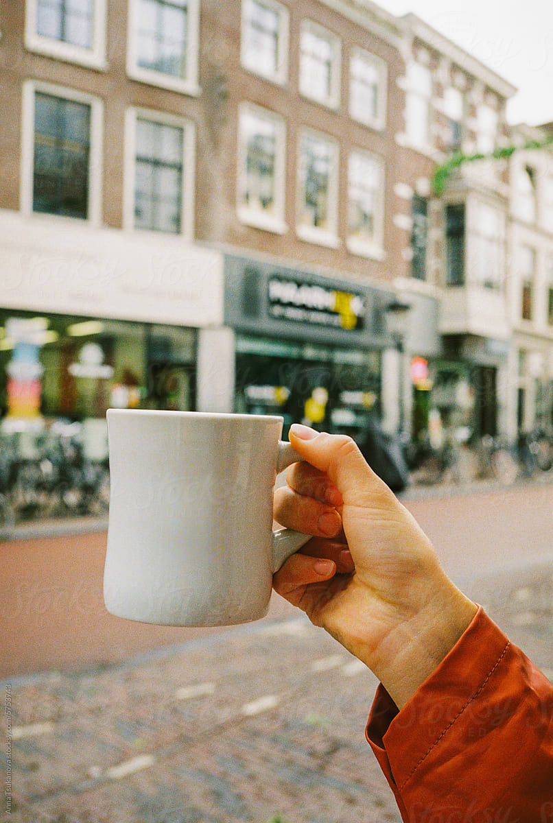 Cup of coffee on the background of Dutch cityscape