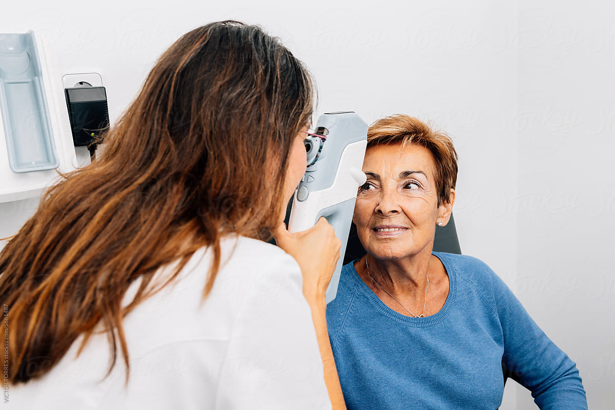 Happy mature woman patient and anonymous oculist doctor