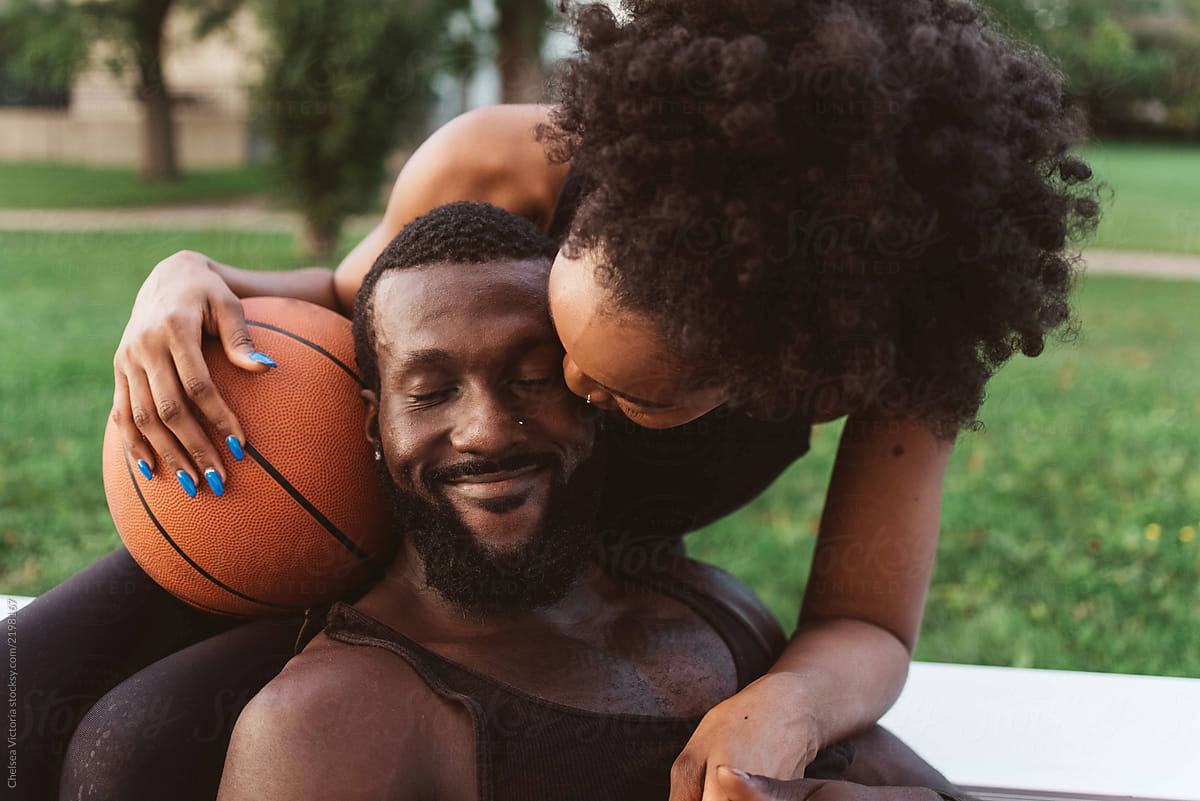 African American Couple playing basketball