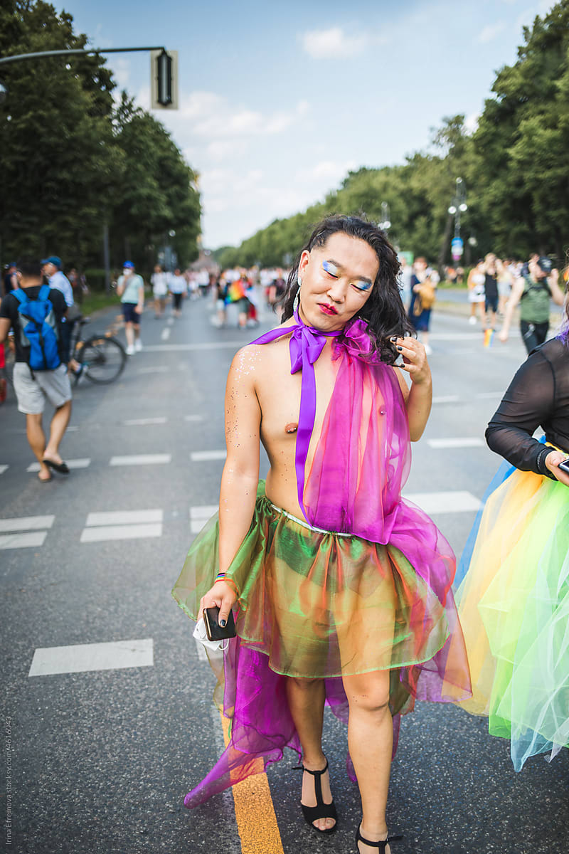 Gorgeous asian man in a rainbow chiffon dress on a Pride in Berlin