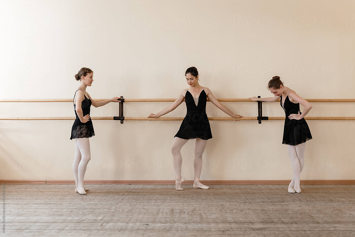 Young ballerina showing exercise to friends