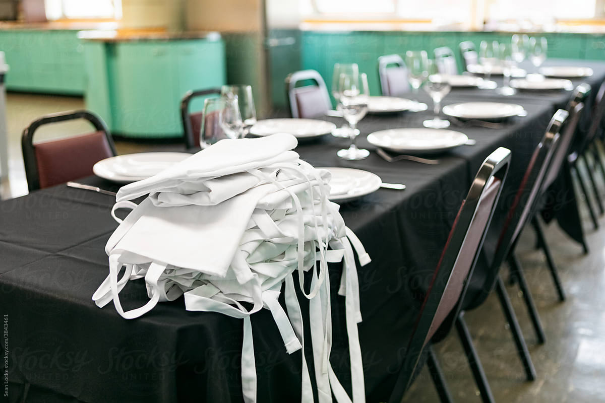 Class: Table Set With Pile Of Aprons For Guestss