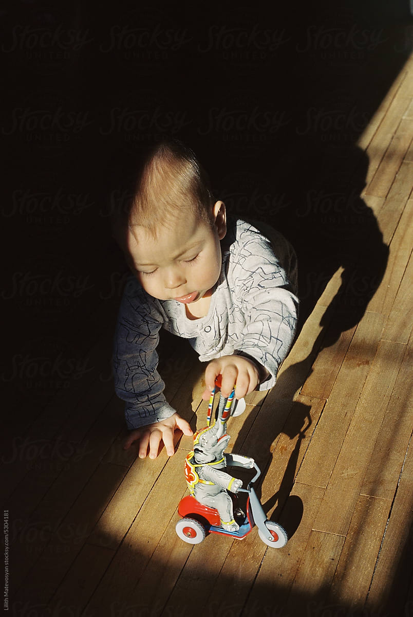 Child Playing With A Toy