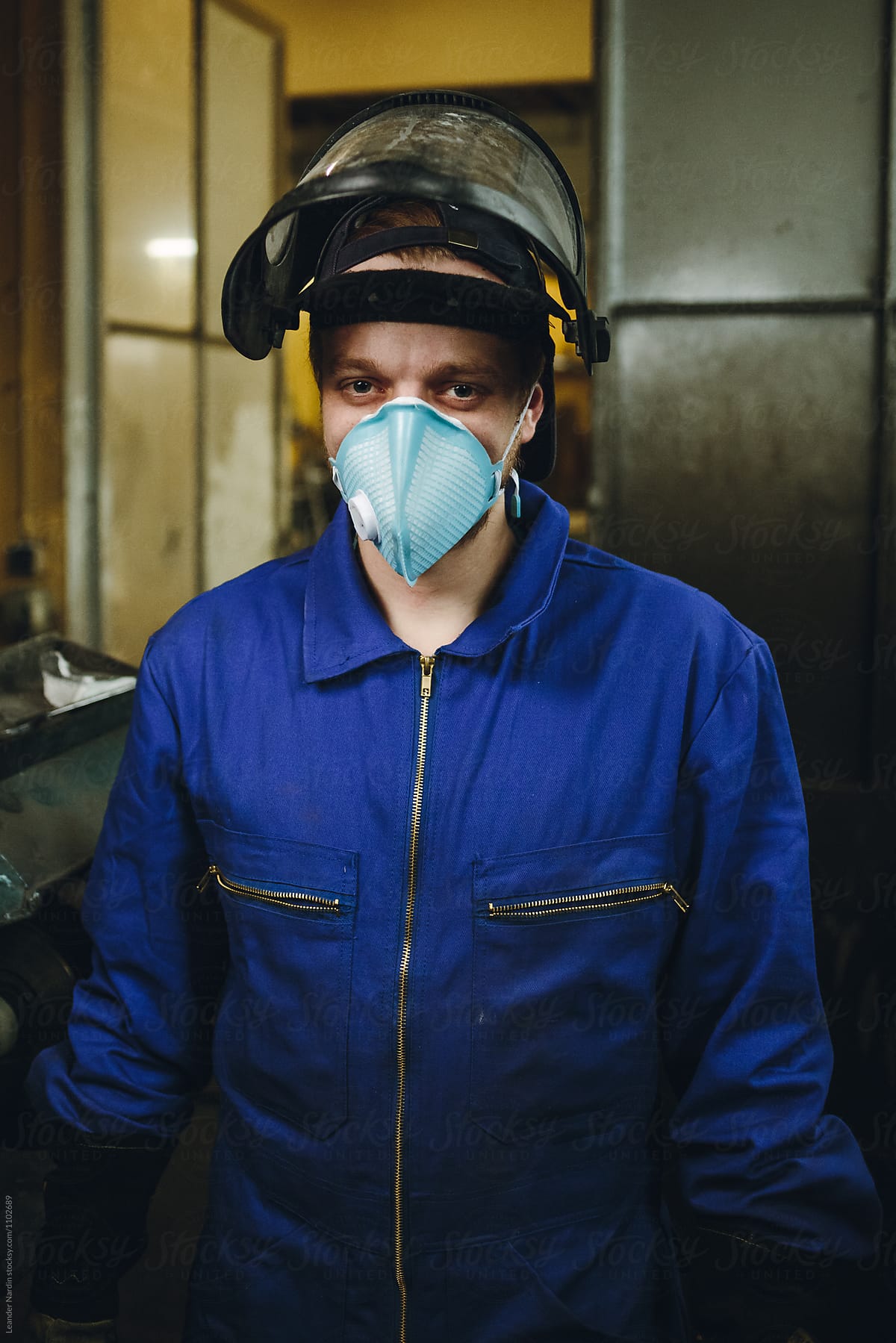 portrait of a metal worker with protection mask  in a workshop