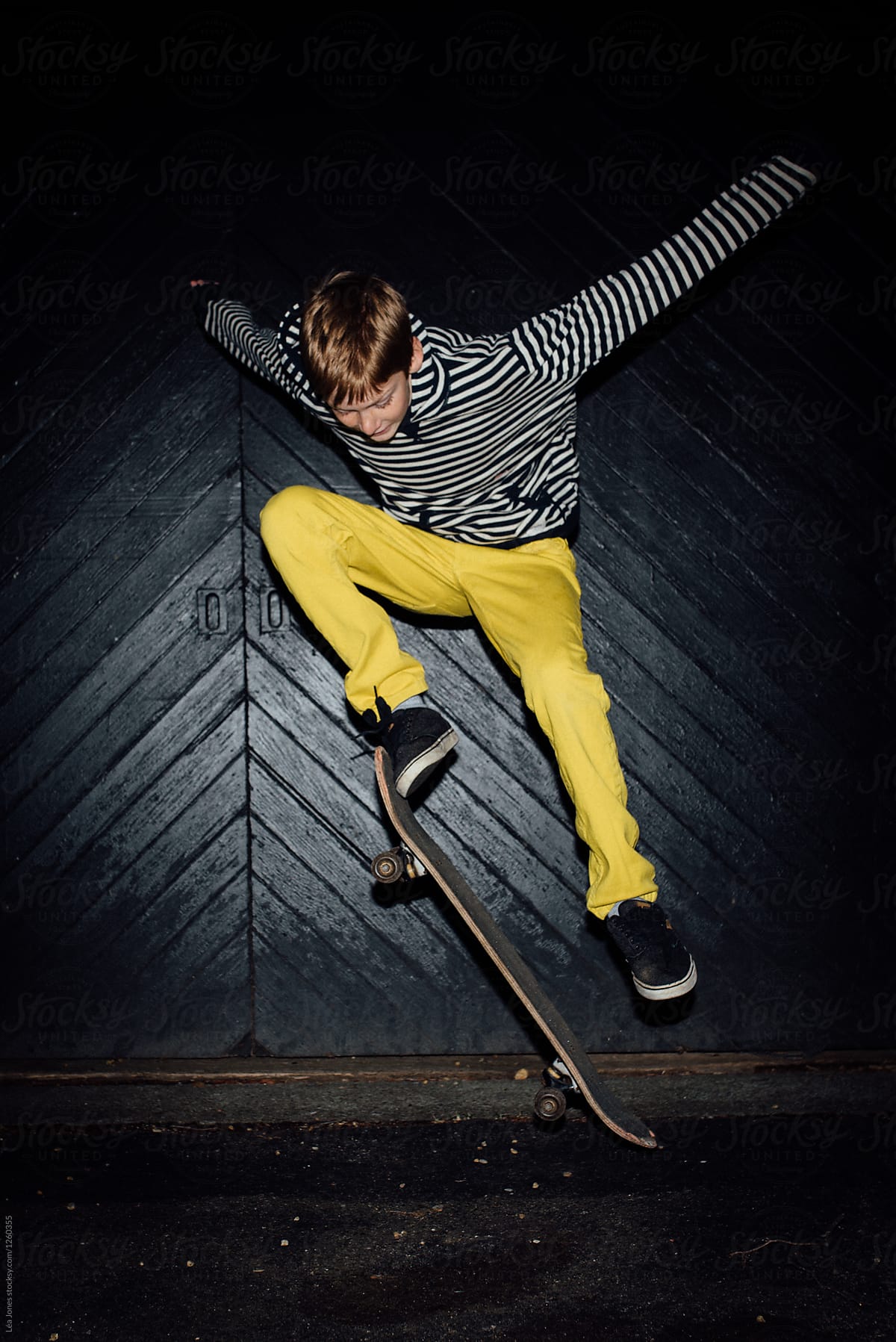 stock photo of teen with yellow trousers on skateboard