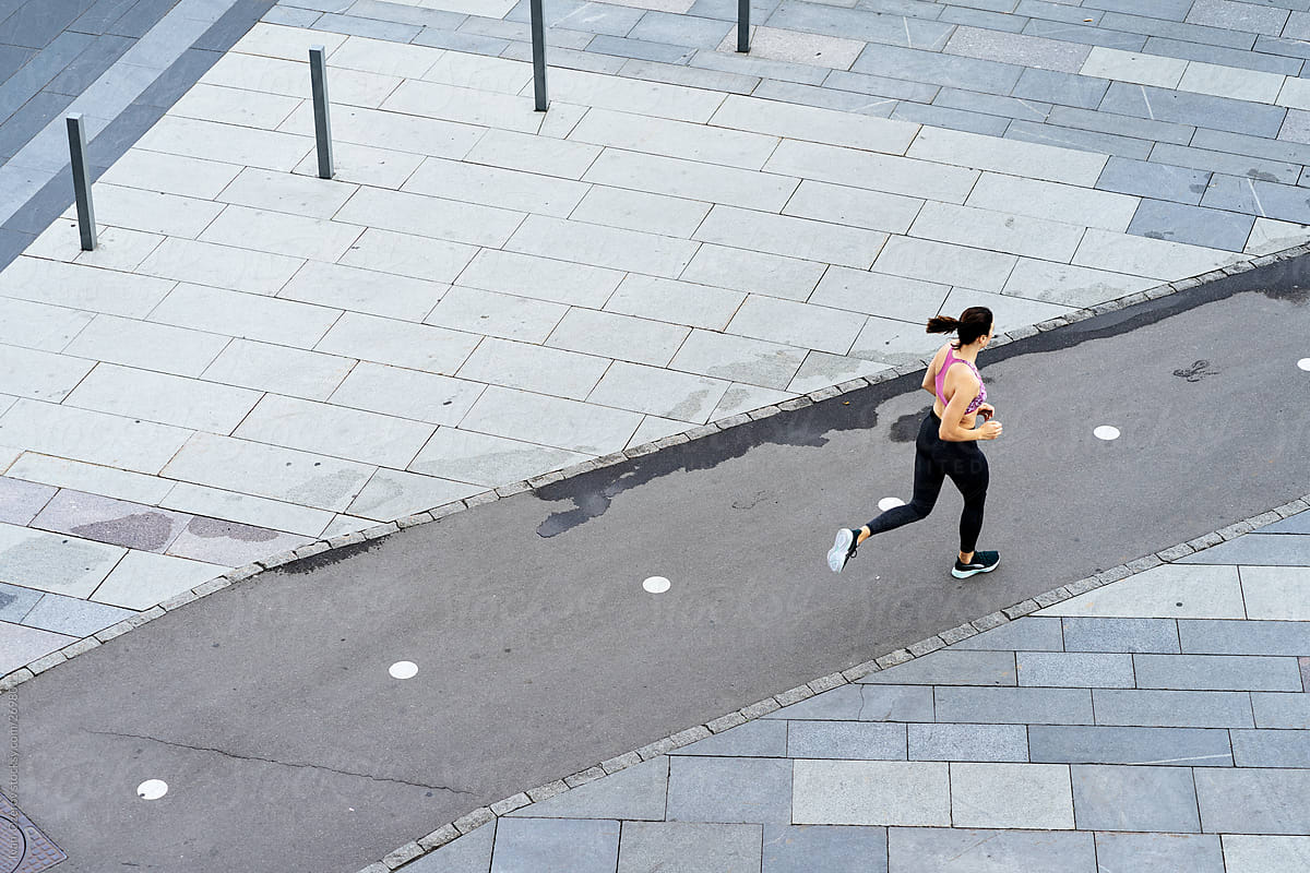 Woman running on street bicycle lane