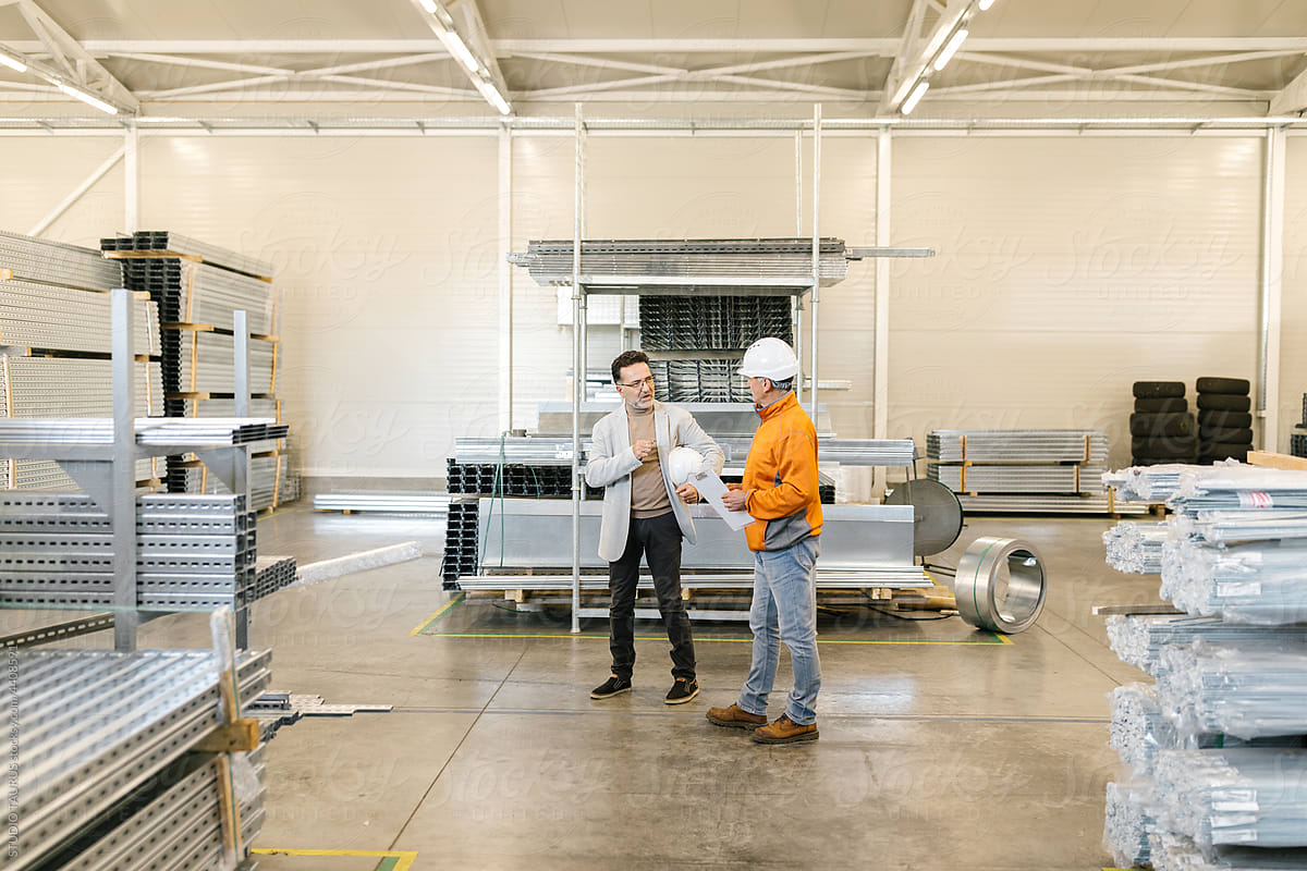 Manager Walking With A Worker In A Factory