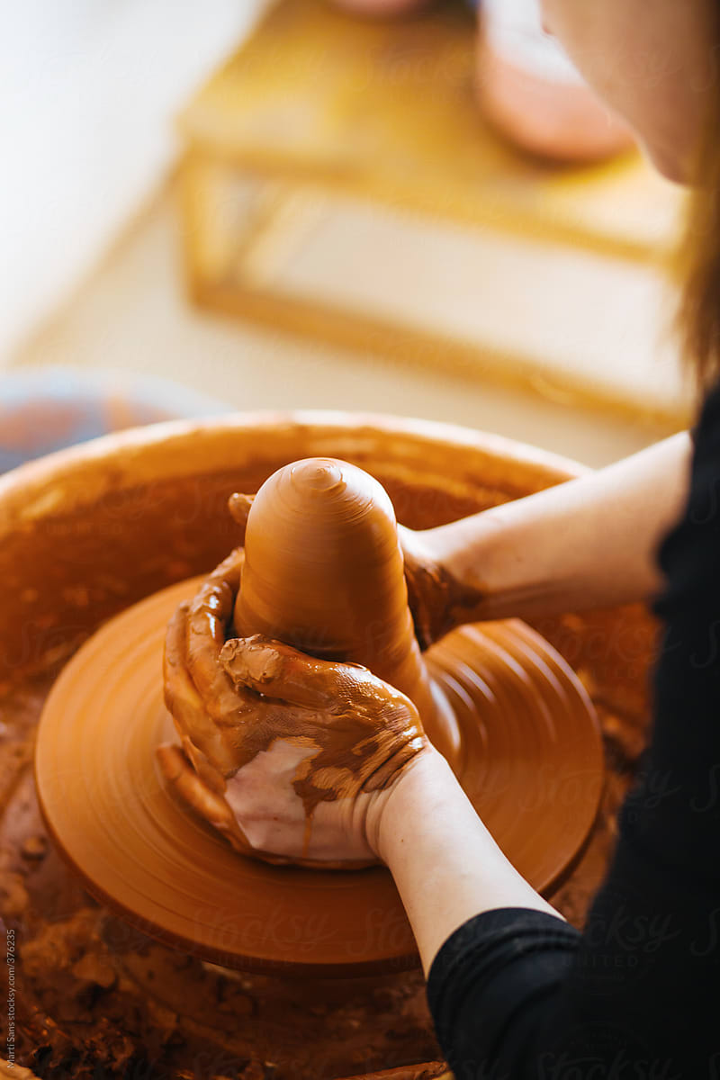 Craftswoman starting a clay vase