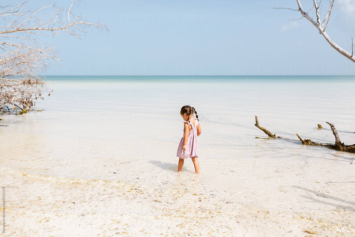 Little Girl Exploring Calm Waters