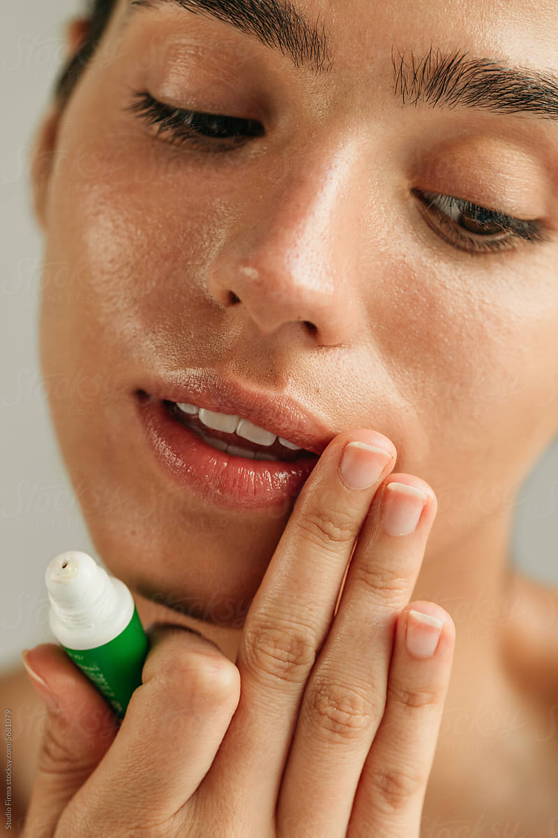 Woman applying lip balm