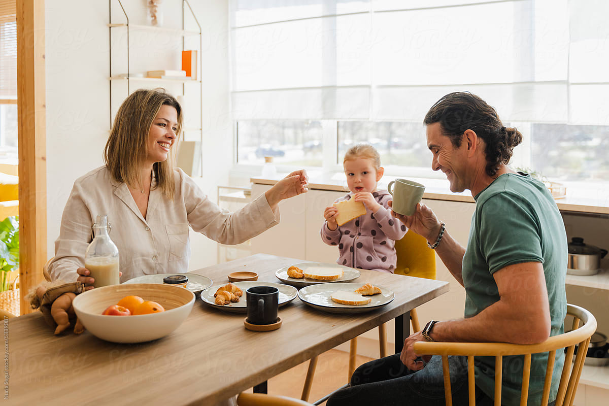 Smiling Family Having Breakfast Together At Home
